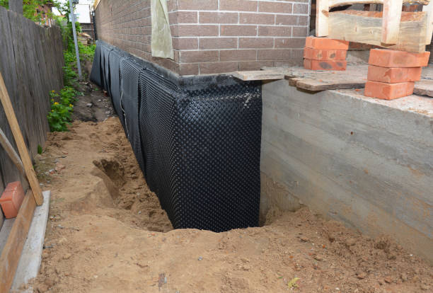 Happy homeowners after waterproofing job in Anoka